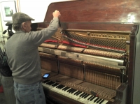 The piano tuner working his magic